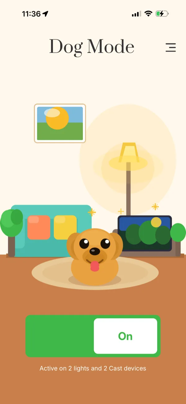 Dog Mode app, on state — the same room glowing warm, the dog awake and alert, with nature visuals on the display.
